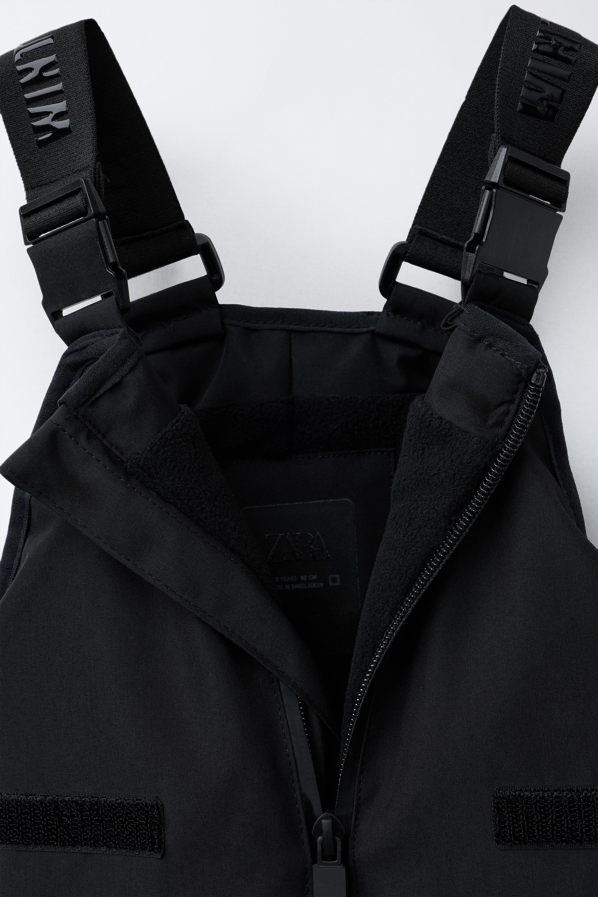 SALOPETTE LONGUE RÉSISTANTE À L'EAU ET AU VENT AVEC POCHES